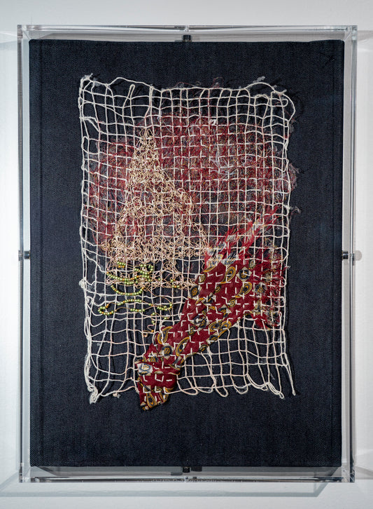It is a piece of dark denim on which a network of white threads (that seem to magically stick together) hold the relic of a tie making a pathway towards a "mountain" made from beaten crocheted gold wire which has holes and irregularities. There is a cloud of red tie threads above it and a complicated beaded gold wire decorating it.  thinking about the complexity and confounding problems of late stage capitalism
